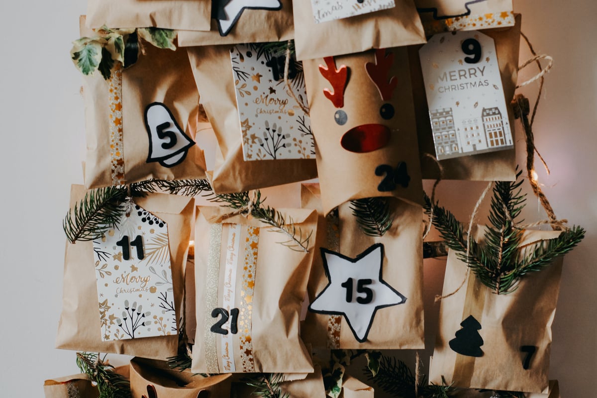 A christmas advent calendar with paper bags hanging from it